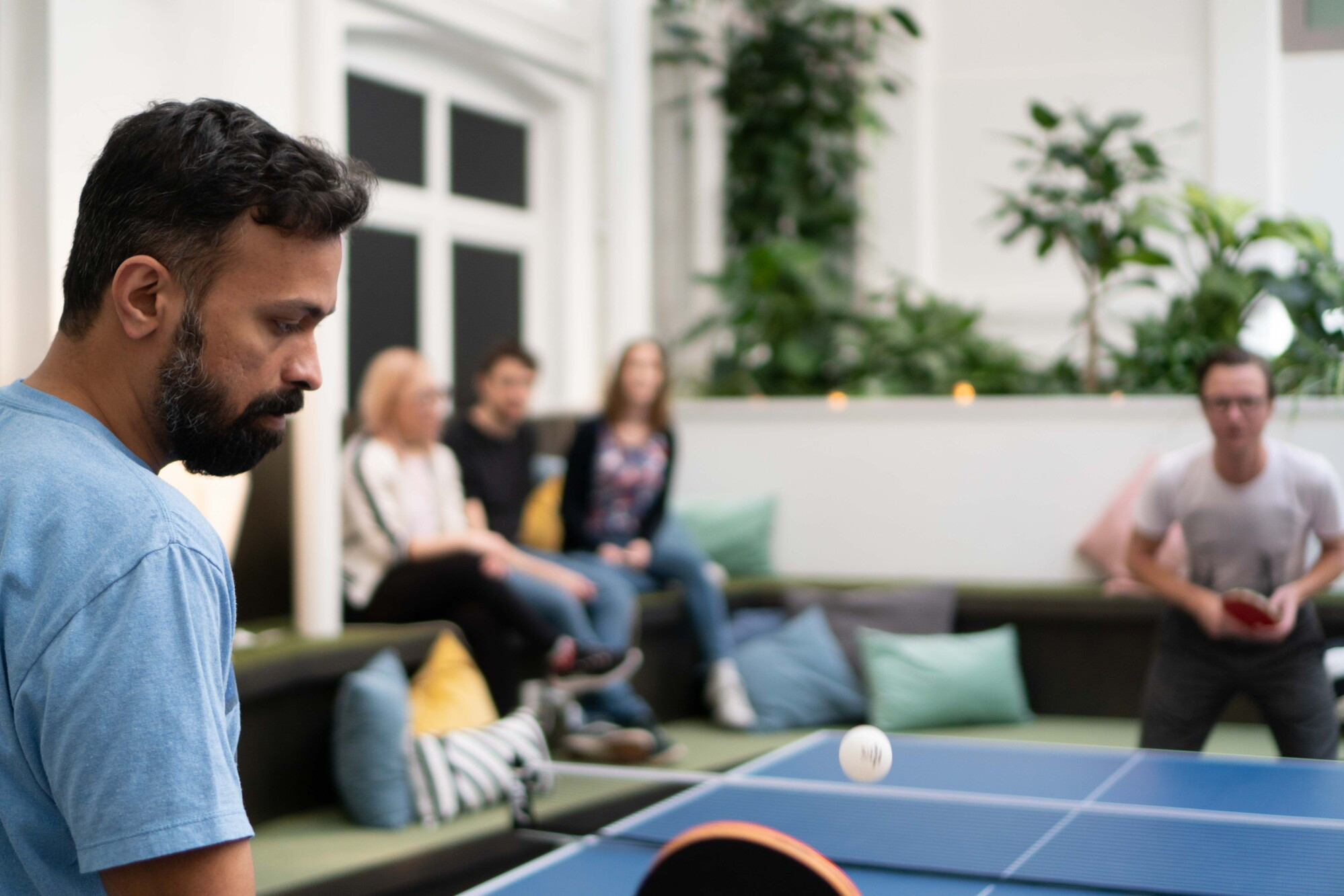 People playing ping pong at DevHub