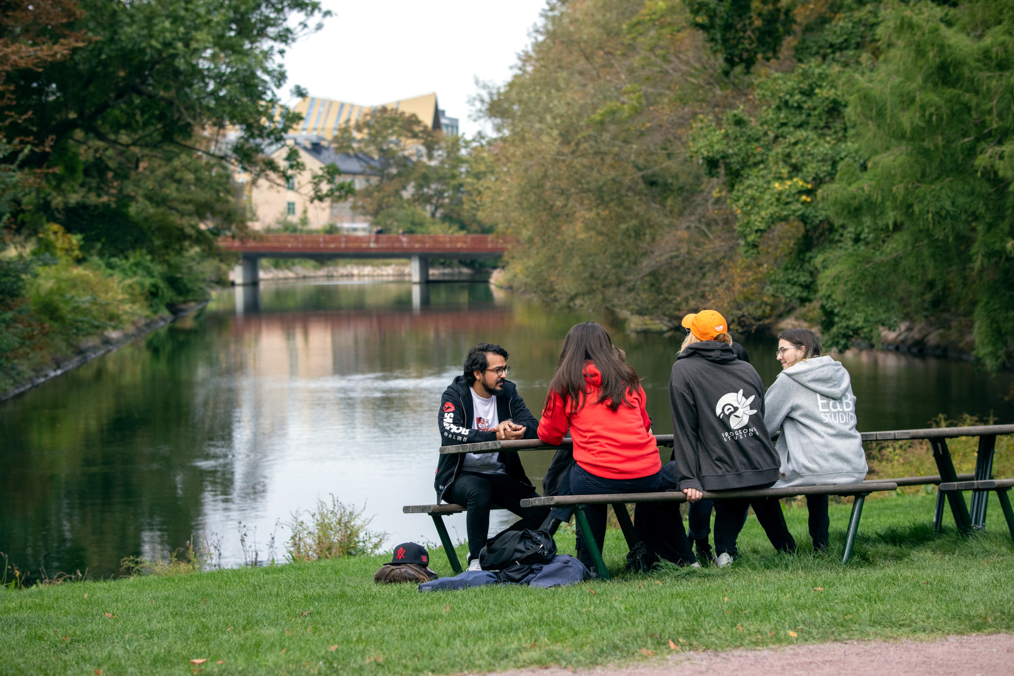 Game developers sitting at a bench in the park