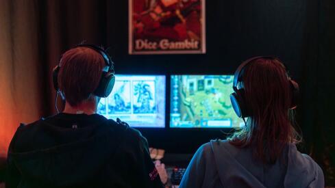 Two game developers in front of computer screens